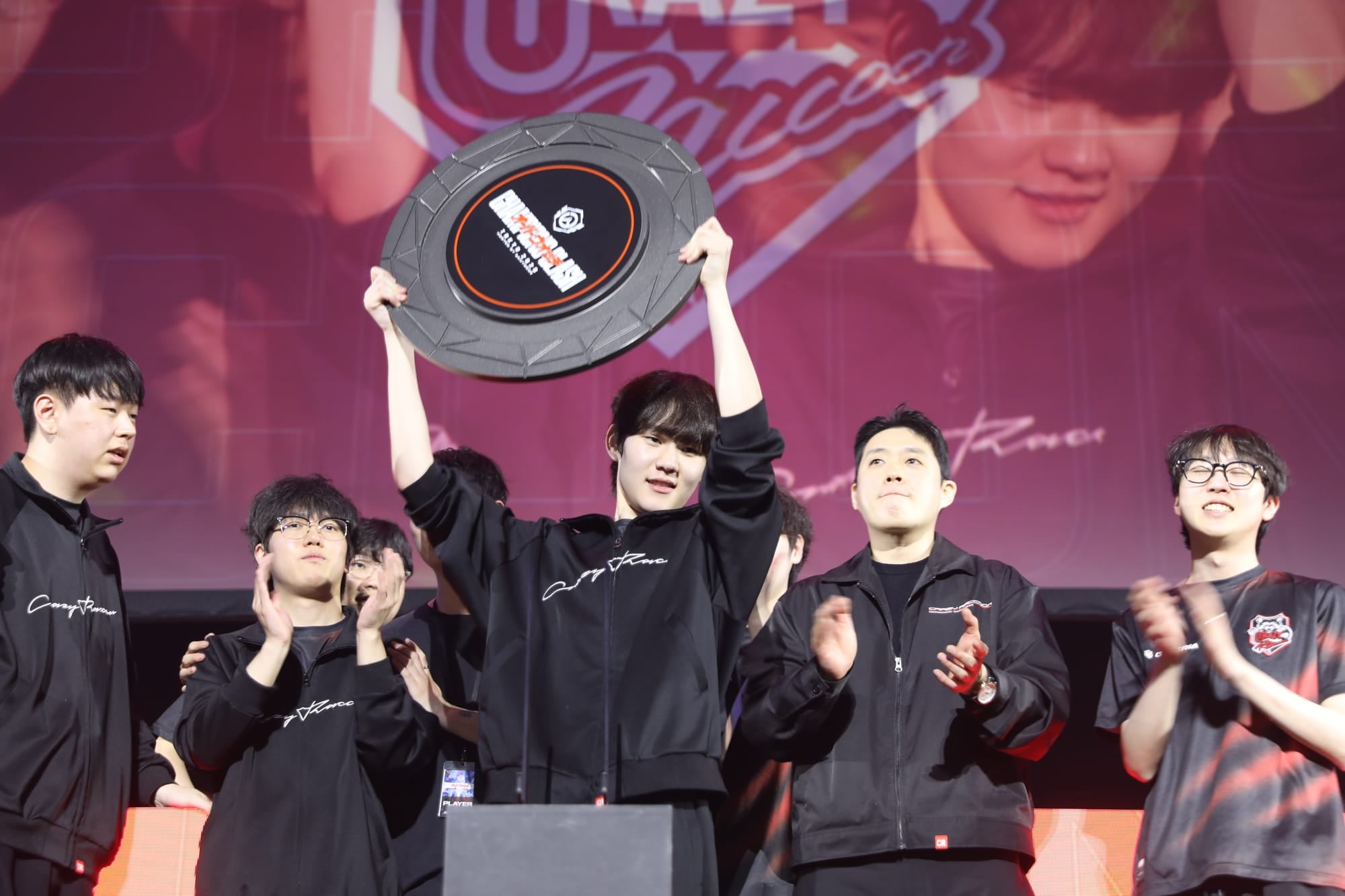 Crazy Raccoon lift the Champions Clash 2026 trophy. Photo by Blizzard Entertainment and GANYMEDE.