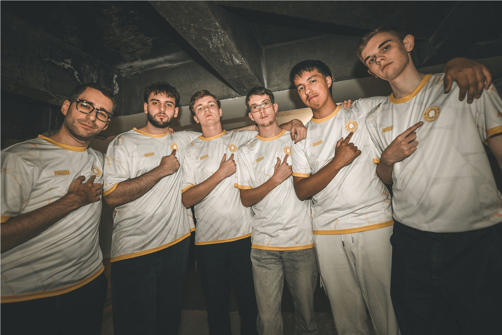 Team Peps line up for a group photo in a basement.